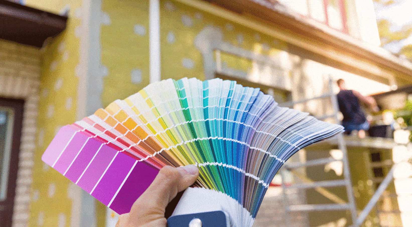 A woman painting a wall